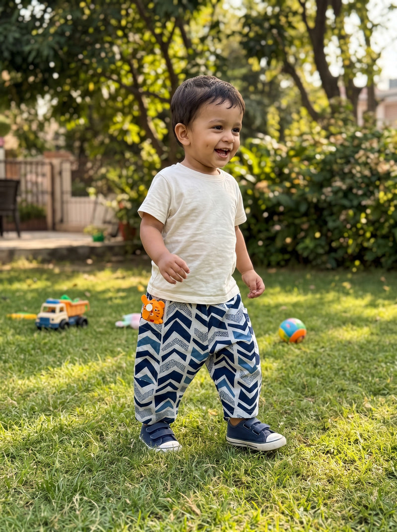 Toddler walking in the Indigo Chevron cotton pants (styled image)