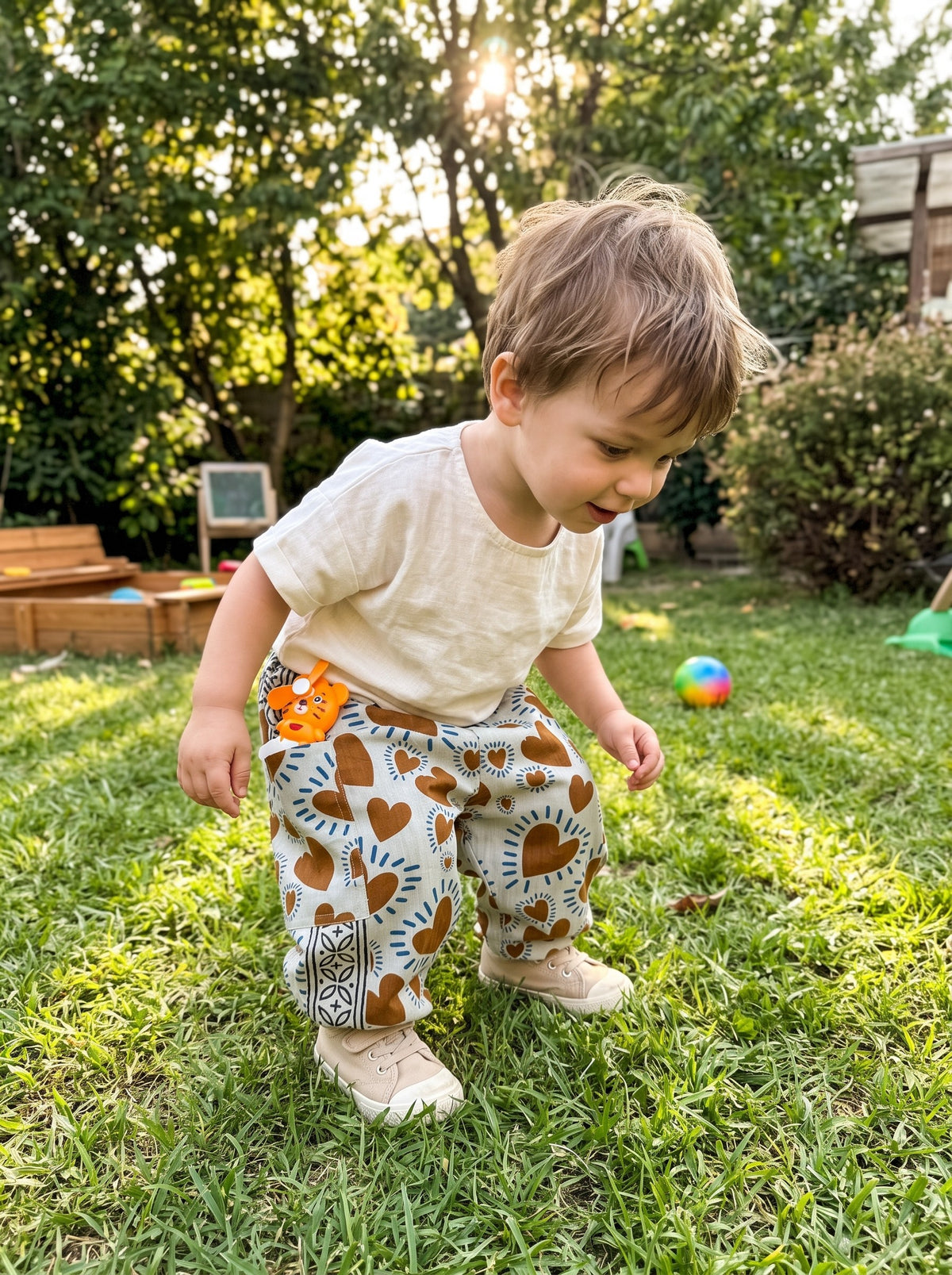Toddler in the Rust Heart cotton pants outdoors (styled image)