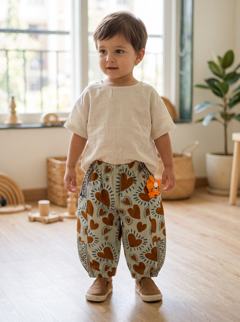 Toddler in the Rust Heart cotton pants indoors (styled image)