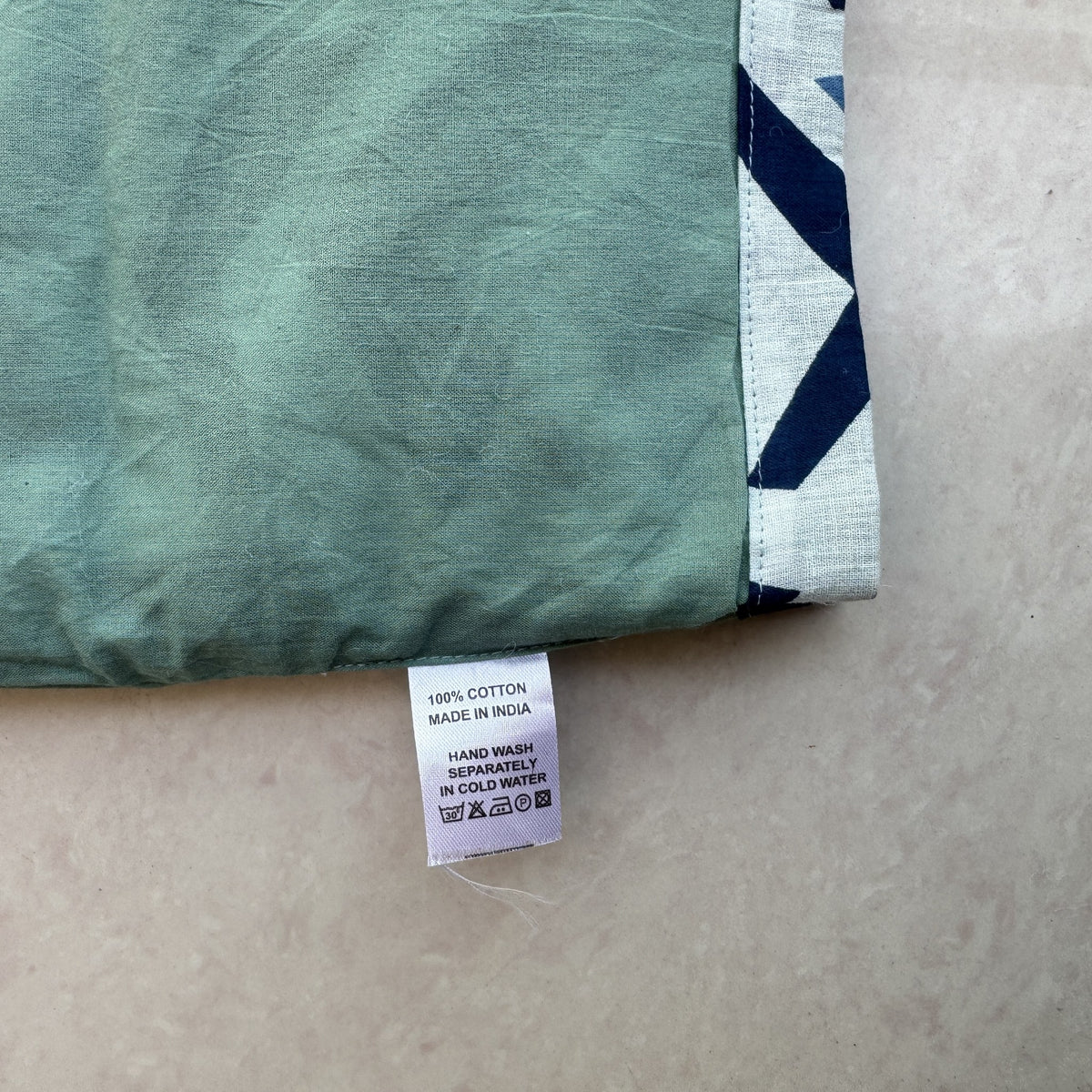 Double-layer Cotton Jumpsuit in Indigo Chevron, real photo: care label on green layer