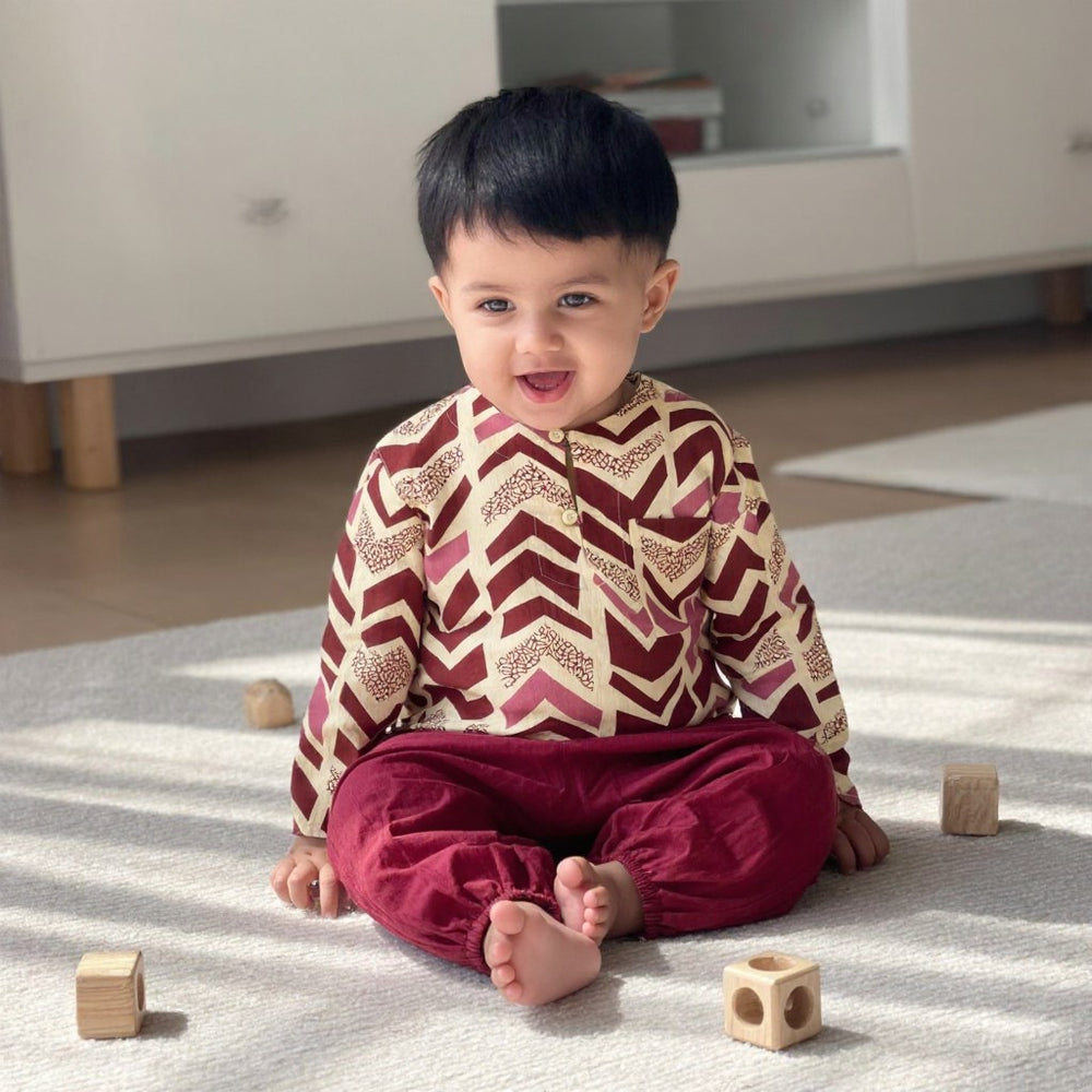 Toddler sitting in the Rosewood Chevron kurta set (styled image)