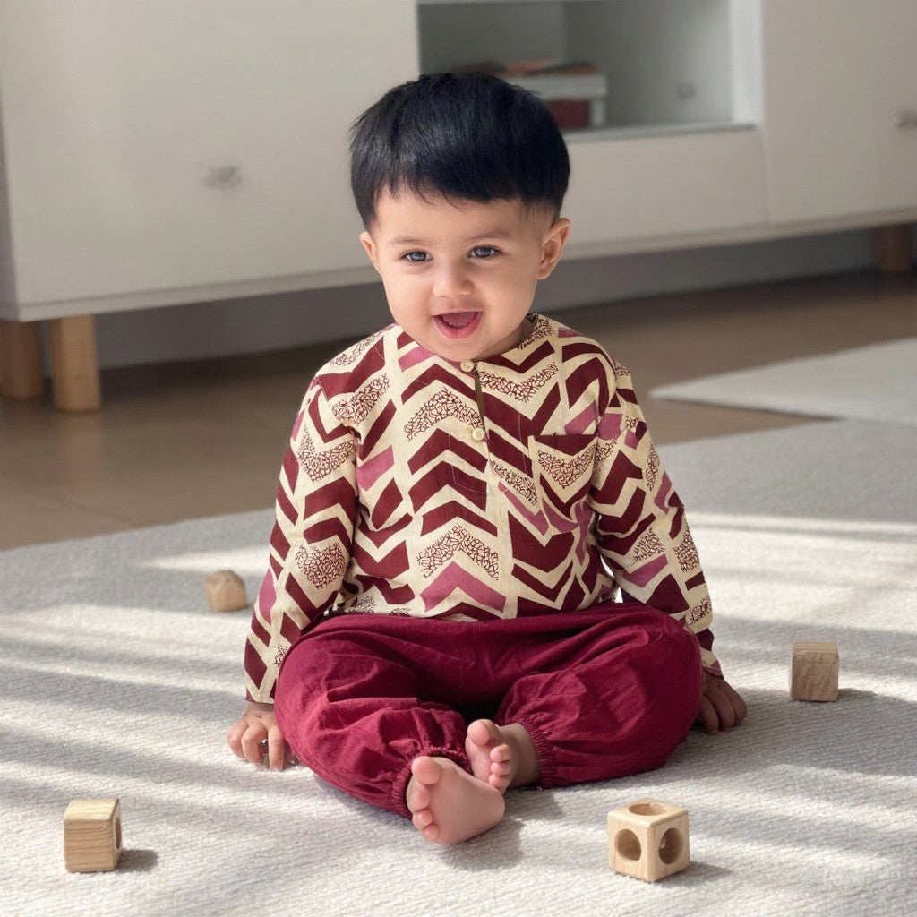 Toddler sitting in the Rosewood Chevron kurta set (styled image)