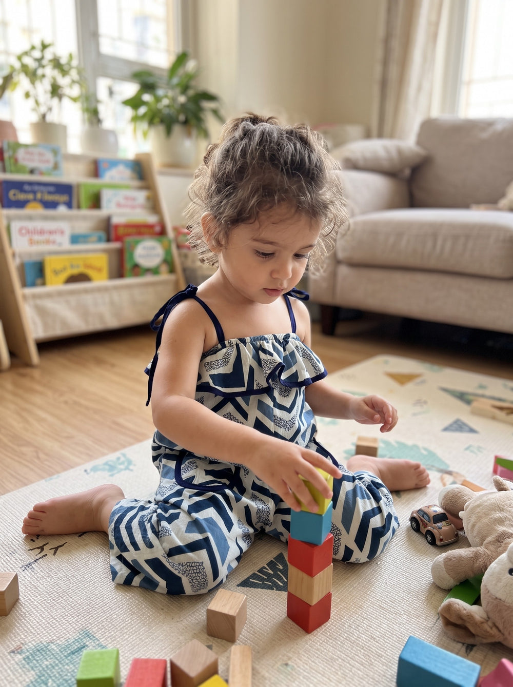 Toddler playing in the Indigo Chevron jumpsuit (styled image)
